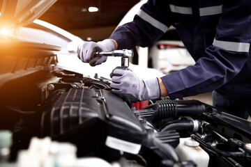 Auto mechanic working on car engine in mechanics garage.Repair service,car service, repair, maintenance concept.