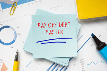 Business concept meaning PAY OFF DEBT FASTER with inscription on the piece of paper.