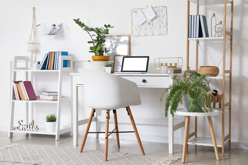 Comfortable workplace in interior of light room