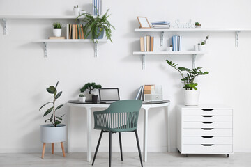 Comfortable workplace in interior of light room