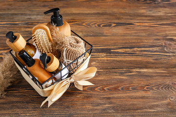 Gift basket with cosmetic products on wooden background