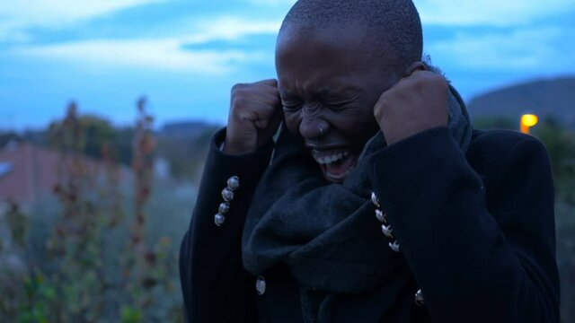 despair, anguish - young black woman screams desperately feeling helpless