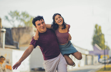 Young happy couple spending time on the street.