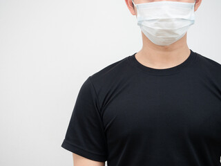 Closeup face of man wearing protect mask against covid-19 black shirt white background isolated