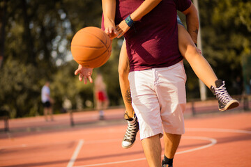 Young happy  couple playing basketball.