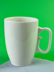 Gray cup with a handle on a green background