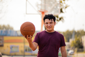 Man on basketball court holding ball.  This is my lucky ball.