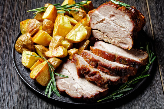 Whole roasted pork loin with baked potato wedges