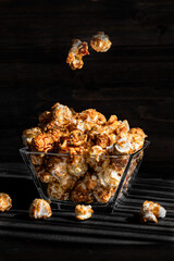 Pop corn feed in glassware on a wooden table