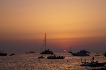 a beach on the island of Ibiza with boats at dusk on a summer night. Balearic Islands, Spain


