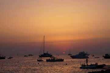 a beach on the island of Ibiza with boats at dusk on a summer night. Balearic Islands, Spain


