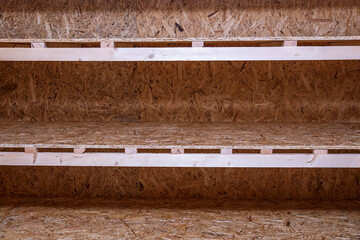 OSB racks, shelves are designed for storing things. Dressing room in the house. Organization of spaces in the house. Shelves in the garage.