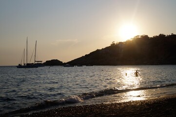 a beach on the island of Ibiza with boats at dusk on a summer night. Balearic Islands, Spain


