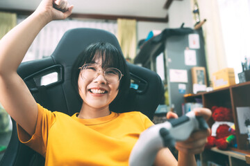 Young adult asian gamer woman wear eyeglasses play a online game.