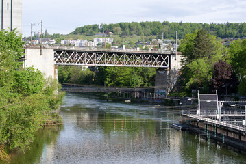 Fototapeta premium Iron railway bridge with stone pillars at industrial district at City of Zurich. Photo taken May 10th, 2021, Zurich, Switzerland.