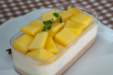 Mango cheesecake on white plate