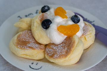 Pancakes with blueberries and orange