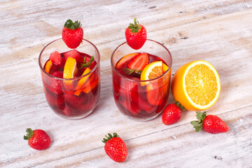 Cocktail drink-orange juice fresh juice with strawberry with lemon orange, mango, pineapple, apple, grapes isolated on white background. High-resolution image