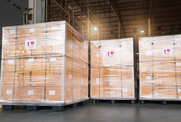 Stacked of Package Boxes Wrapped Plastic Flim on Plastic Pallets at Storage Warehouse. Shipment Boxes. Cargo Export- Import. Shipping Warehouse Logistics.
