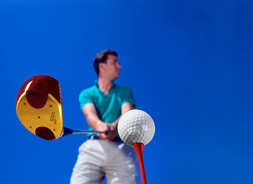 man preparing to tee off with driver.

Model released