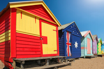 Fototapeta na wymiar A row of colourful multi-coloured wooden beach huts at Brighton Beach, Melbourne, Victoria State, Australia