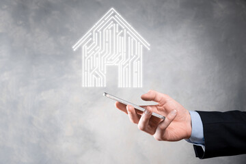 Businessman hold house icon.Smart home controlled, intelligent house, and home automation app...