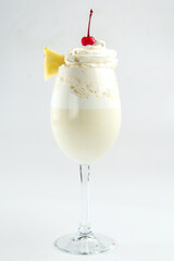 Isolated cream vanilla milkshake with pineapple and cherry