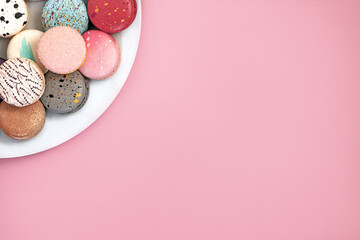 french meringues on a white plate on a pink background, mock up for design, free space