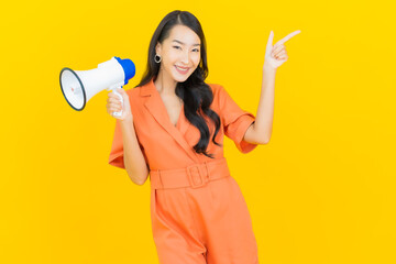 Portrait beautiful young asian woman smile with megaphone