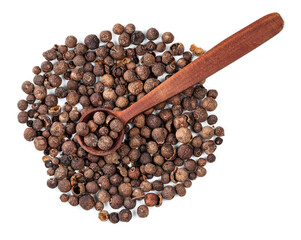 spoon on allspice (jamaica pepper) on white