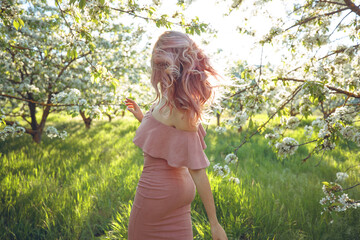 Woman in the spring. Beautiful and fashionable woman in the spring in the garden. High quality photo.