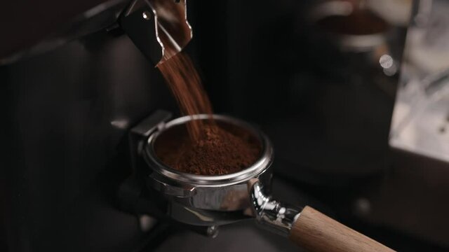 Closeup of grinding fresh coffee into pottomless portafilter