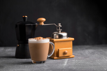 Homemade coffee cappuccino with pot and grinder on the grey background