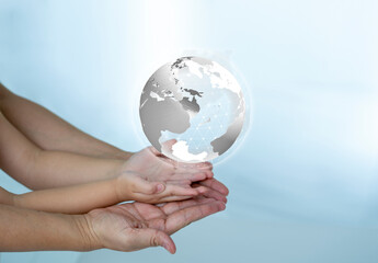 WORLD Icon in Mother and kid hands, bright future concept.