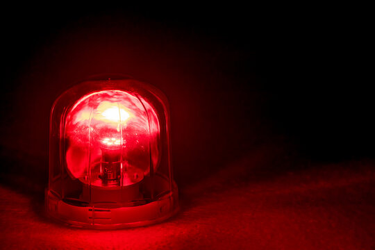 Emergency rotating alarm red light at night.