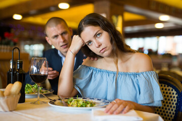 Family quarrel at a table in a restaurant