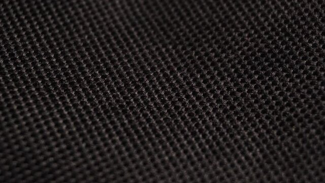 Textile background - black polyester fabric. Slider macro