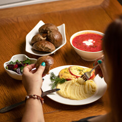 Woman eating Vegetables dishes at wooden table. Set lunch. Delicious and healthy meals. Vitamin vegetarian food. Square format. Close up shot.