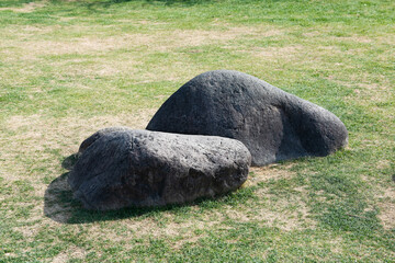 two rocks on green grass. stone middle grass