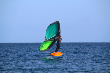 Windsurfer surfing with wing foilboard at the ocean (Tenerife, Spain)