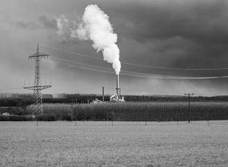 smoking chimney of a factory against sky in Germany