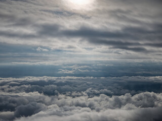 Fototapeta na wymiar Beautiful sunny sunrise cloud clusters in open air blue sky abrove the mountain