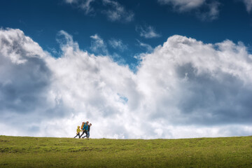 Family hikers against cloudy sky