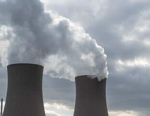 Nuclear power plant against sky at sunset