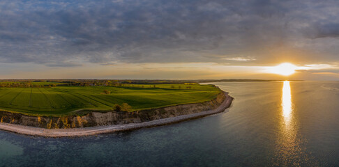 Panorama aerial view of sunset on the steep coast of the Baltic Sea.
