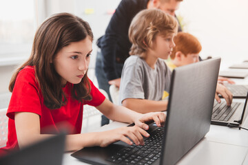 Pupils with teacher during computer science lesson