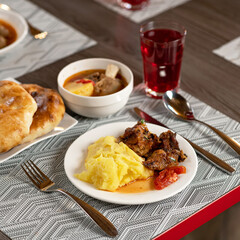 Hearty meals. Set lunch on restaurant dining table. Meat and vegetables Food. Square format or 1x1 for posting on social media. Soft focus.