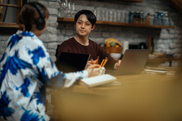 Asian couple working at home via technology