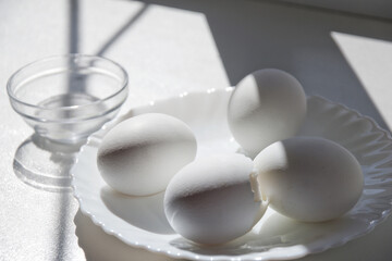 boiled whole eggs in elegant little white porcelain plate