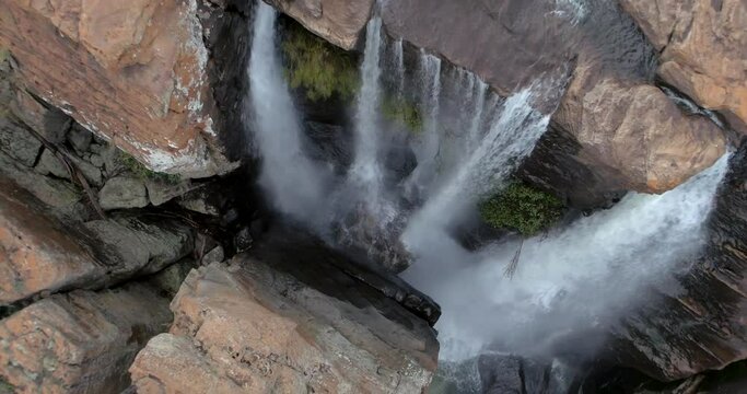 Aerial: Beautiful top down view of waterfall streams rapidly flowing and falling down. Mpumalanga, South Africa - rising shot from a drone.